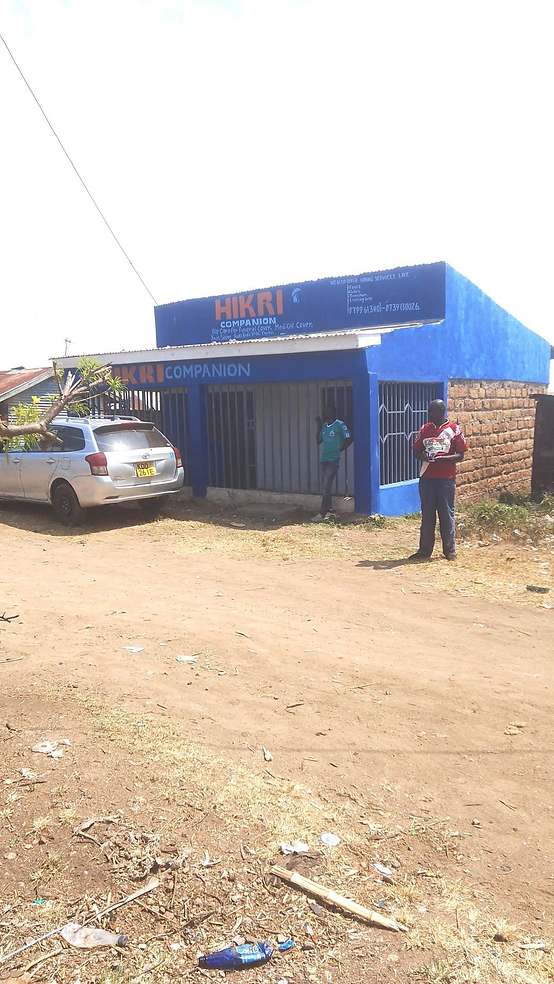 The Hikri Companion office — blue building with branded signage in Kariobangi