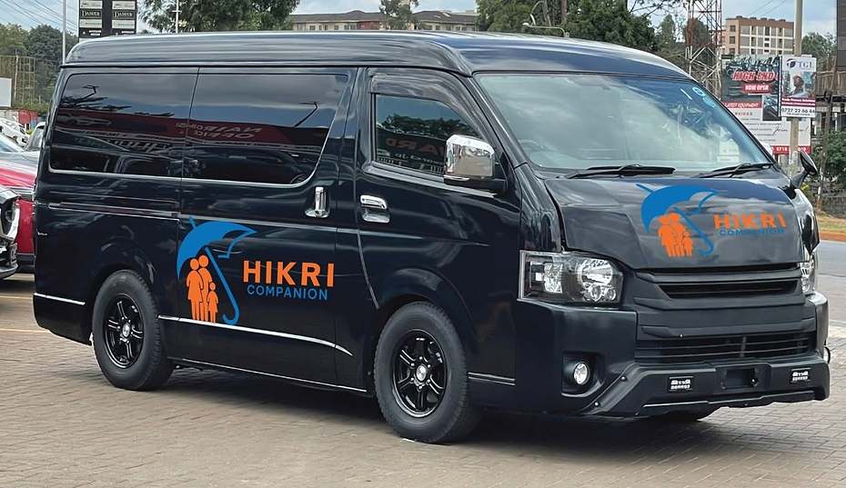A black Hikri Companion branded van parked on a street