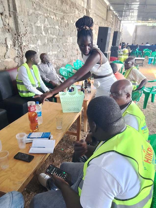Hikri Companion field agents with members at a community event table